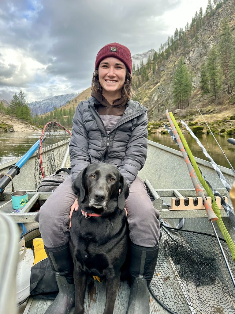 Girl with dog in boat on river
