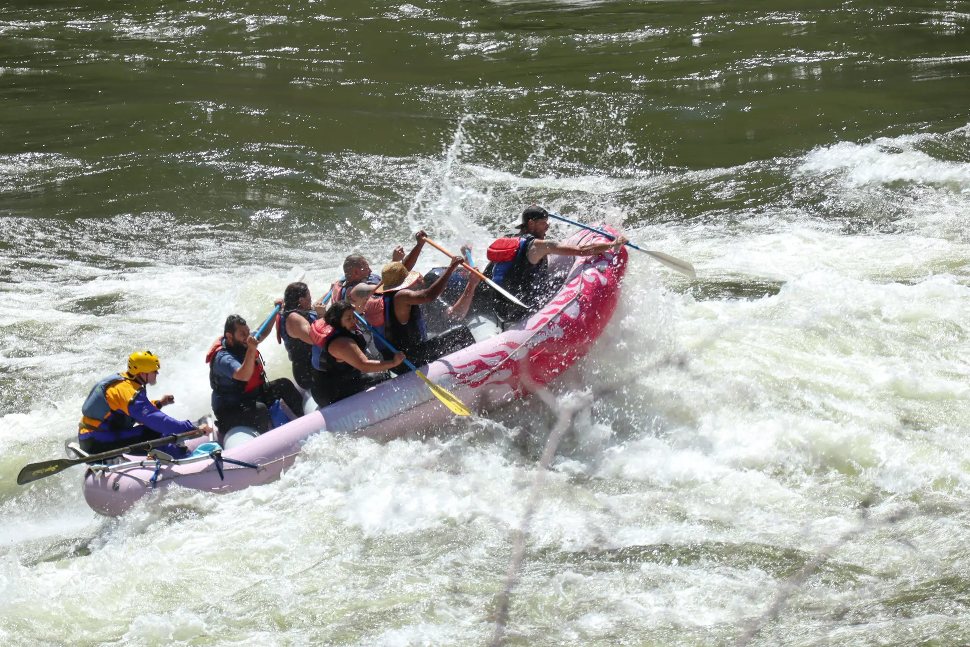 group of people on boat on rapid on river